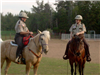 Two officers on horseback talking to each other