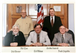 Five male commissioners sitting for camera