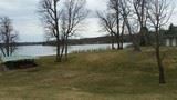 Image of pavilion from atop a hill with lake in background