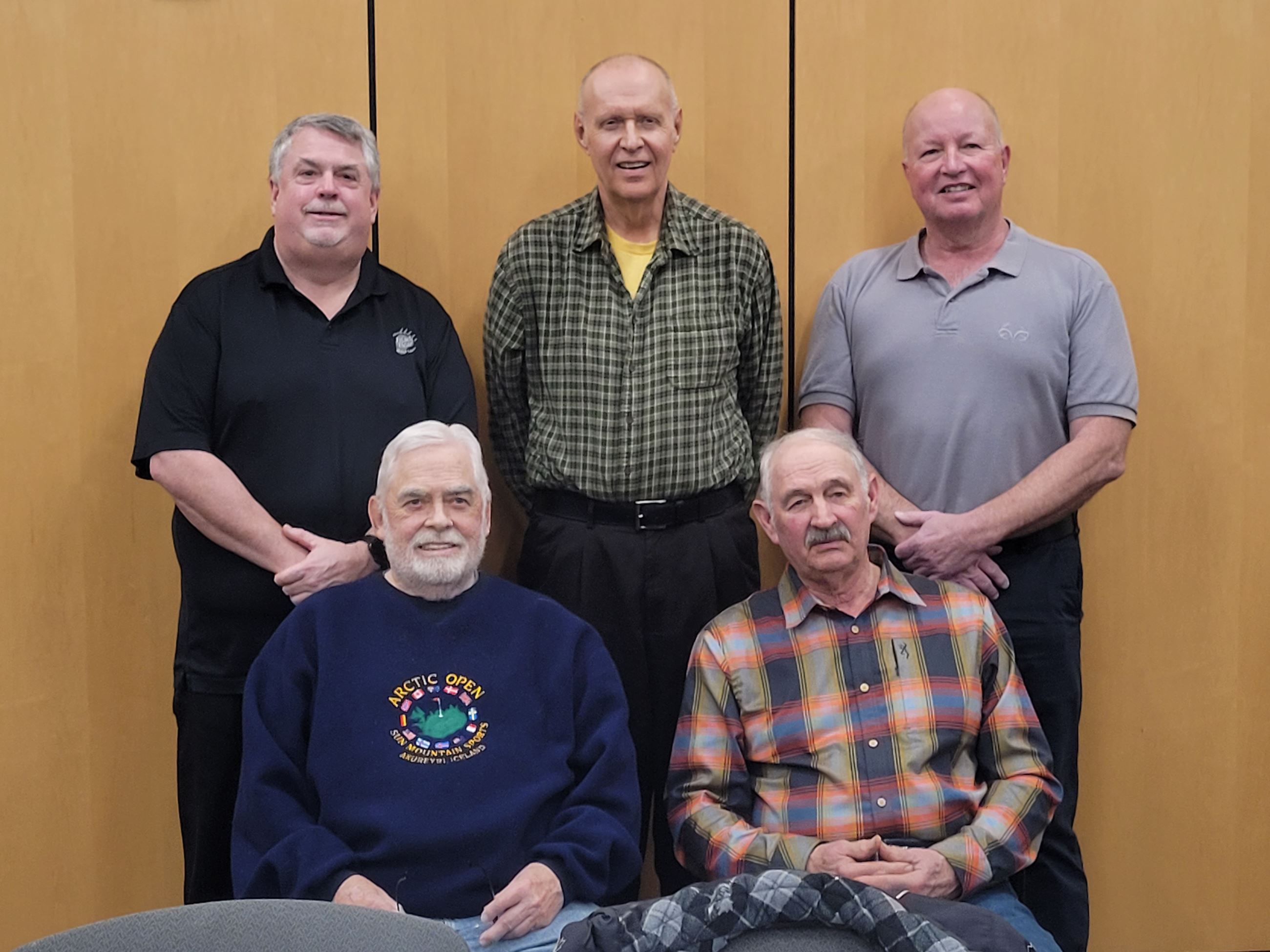 group of five commissioners sitting and standing
